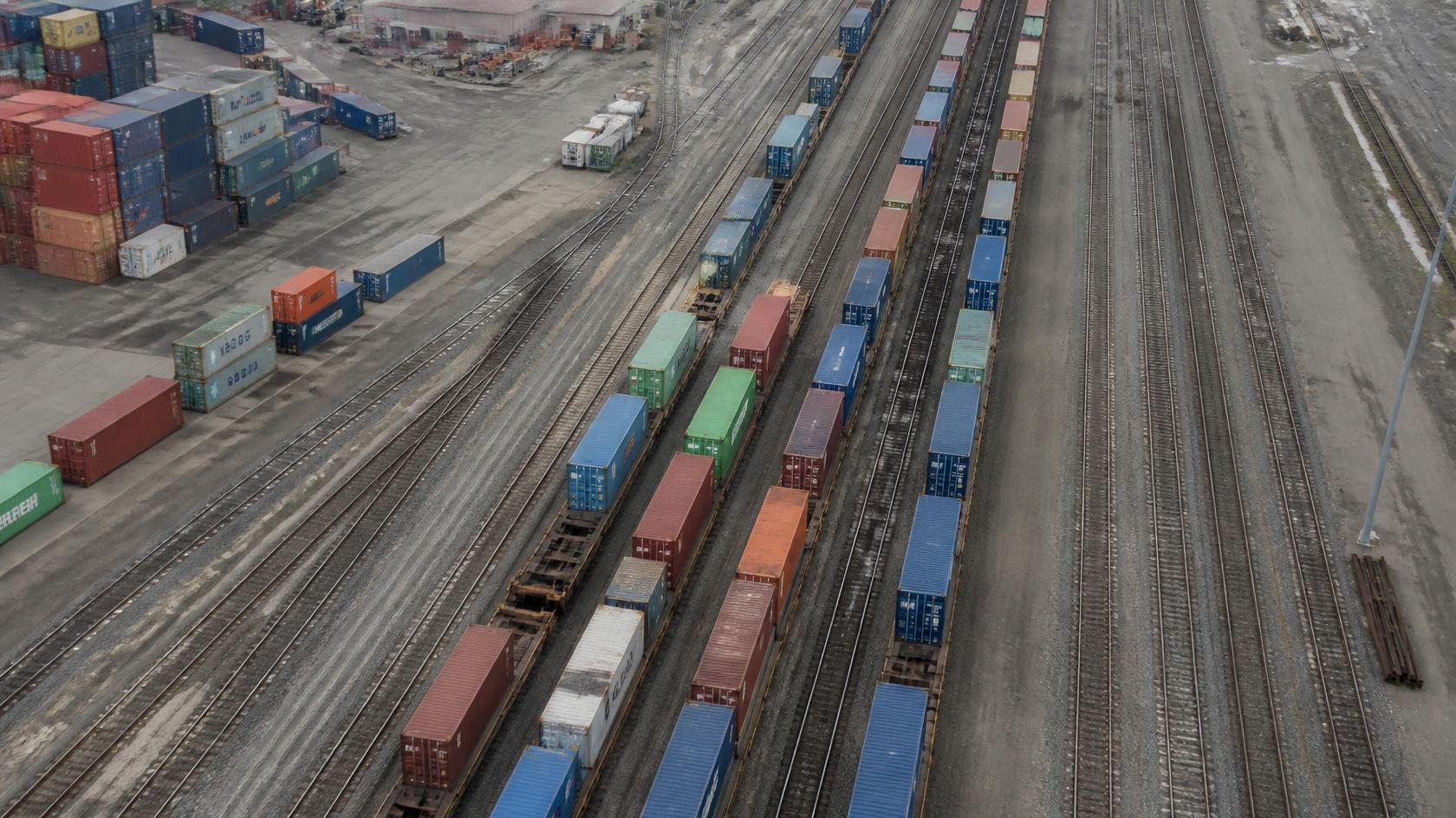 rail freight cars being loaded for cargo shipping